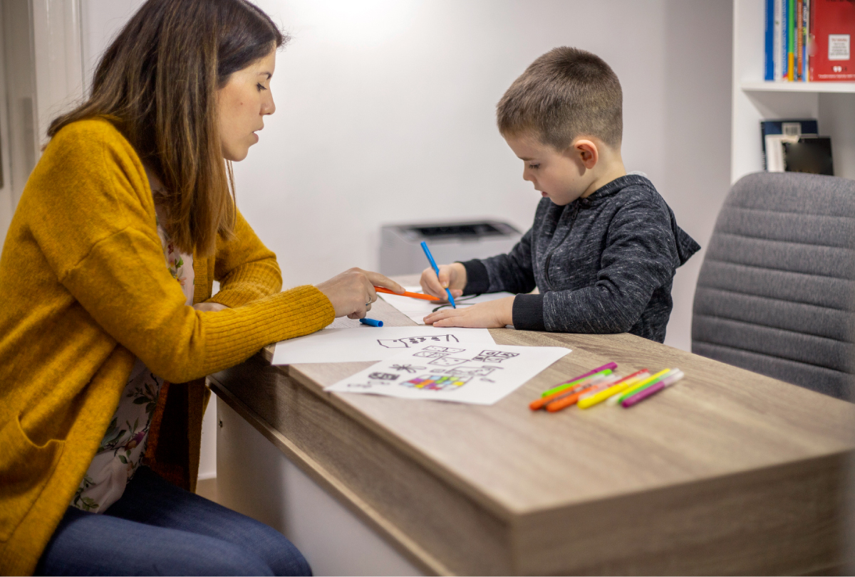 A researcher works with a young child.