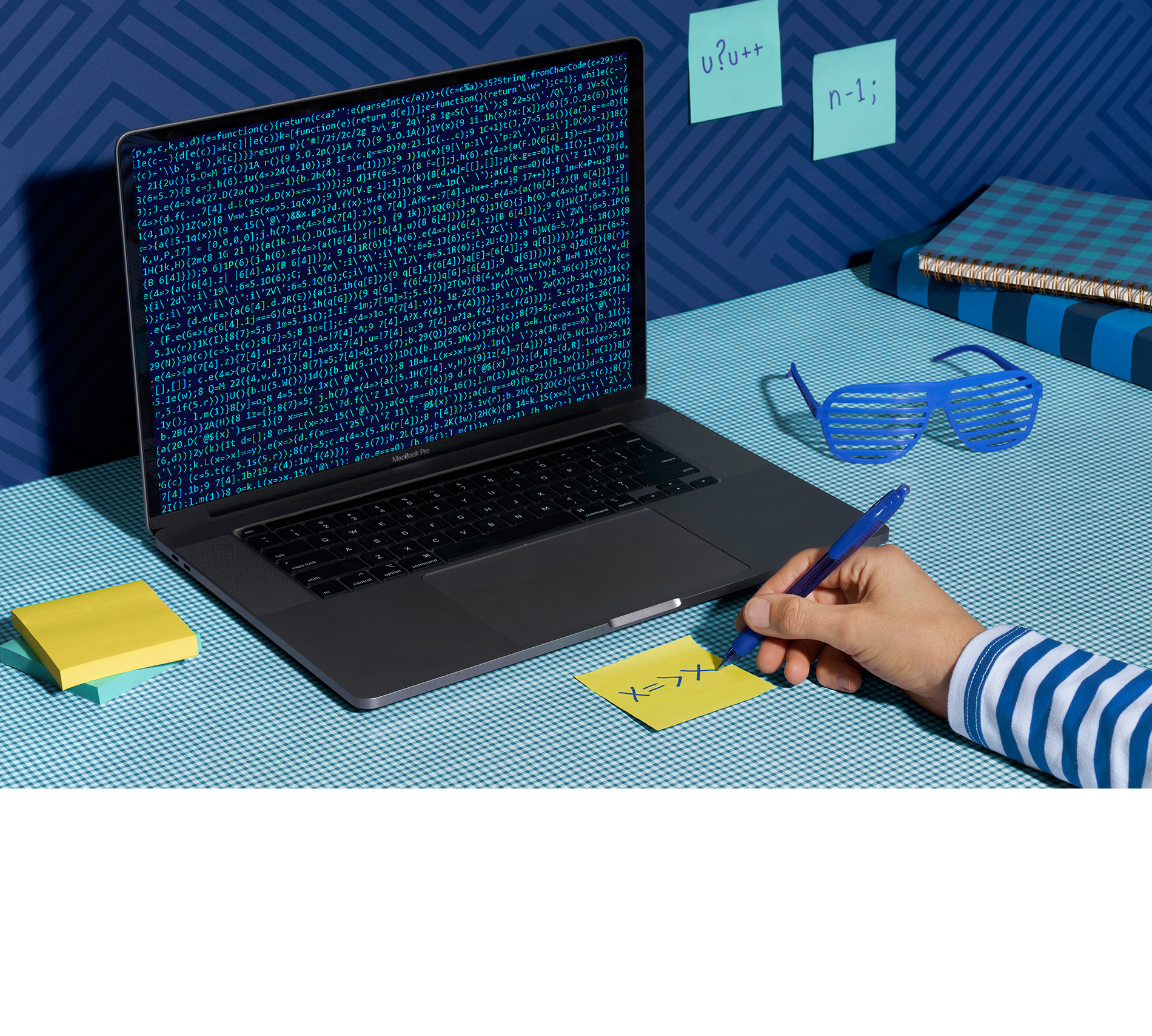 Young man is in front of computer full of code, and finding patterns within it.