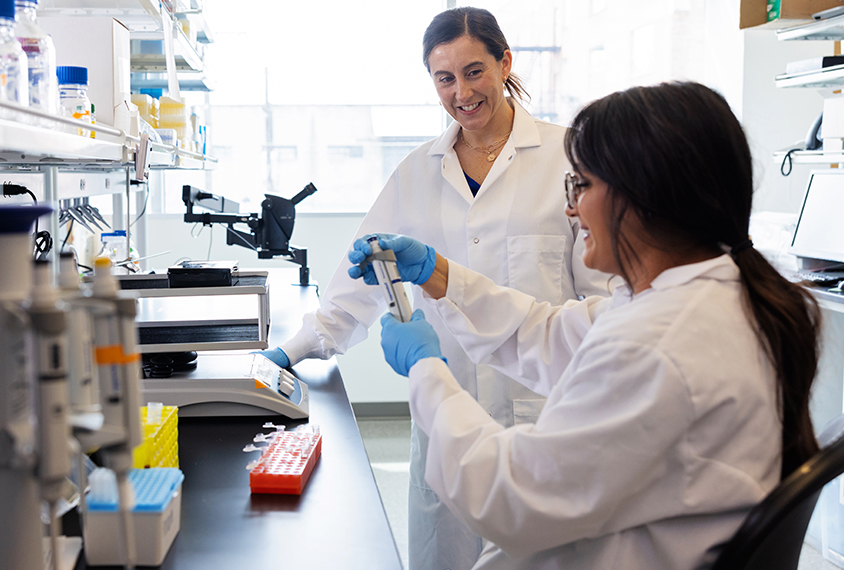 Scientist Lucia Peixoto in her lab with a colleague.