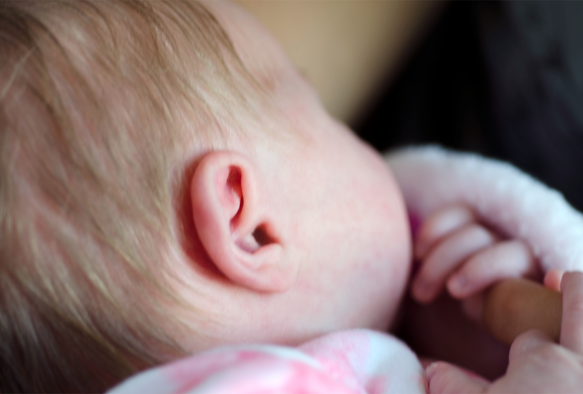 A close-up photograph of an infant’s right ear.