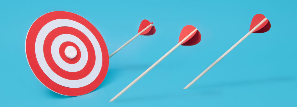 Several arrows have fallen short of their target, which is a pill on a bullseye. This image suggests that a drug targeted towards autism's symptoms has not yet been made.