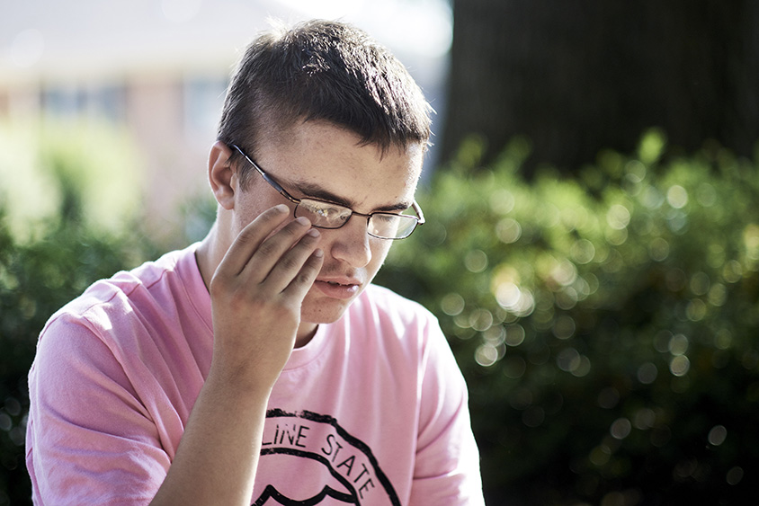 Kyle Becker, 17, sits in a park near home in Potomac, Md., on July 12, 2016. Photo by T.J. Kirkpatrick/Redux