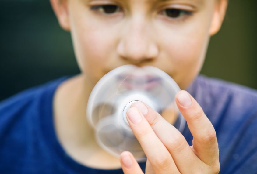 Boy staring at fidget spinner