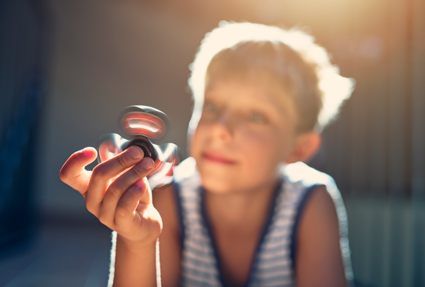 child playing with fidget spinner