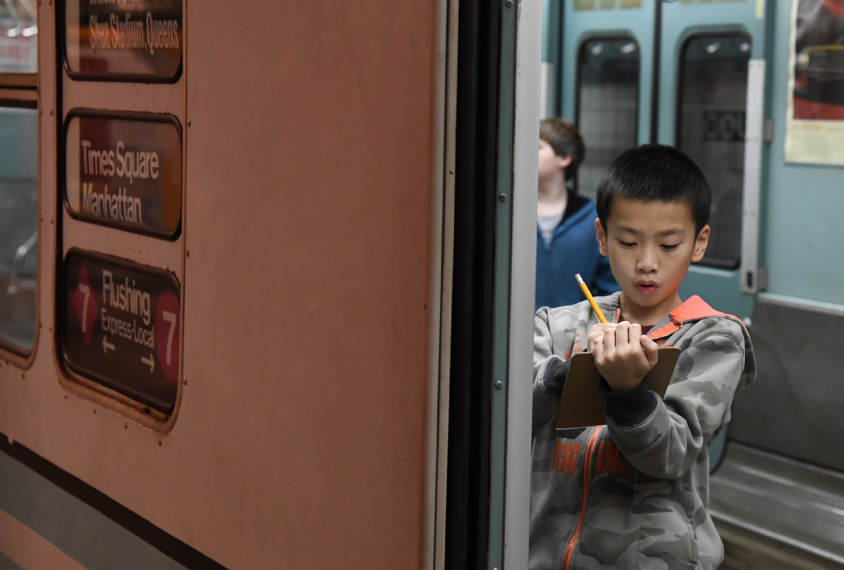 students in subway taking notes