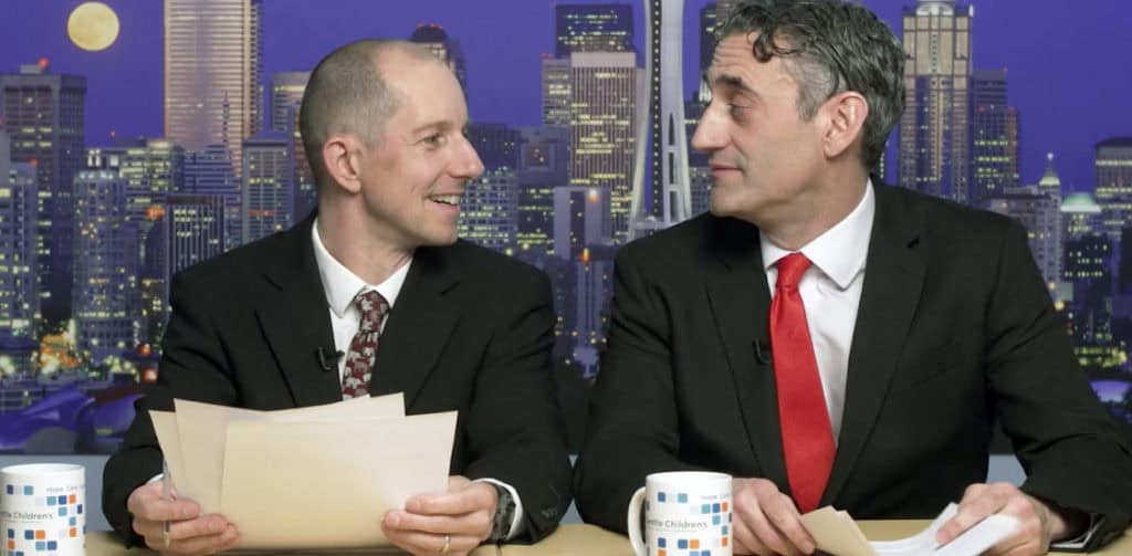 newscast scene, two men with documents