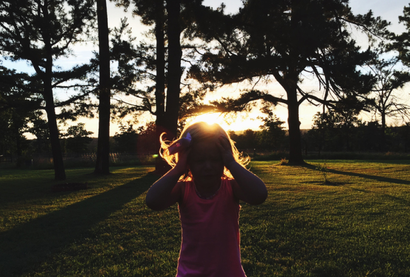 Silhouetted child in the trees