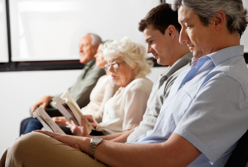 Group of people in medical waiting room.