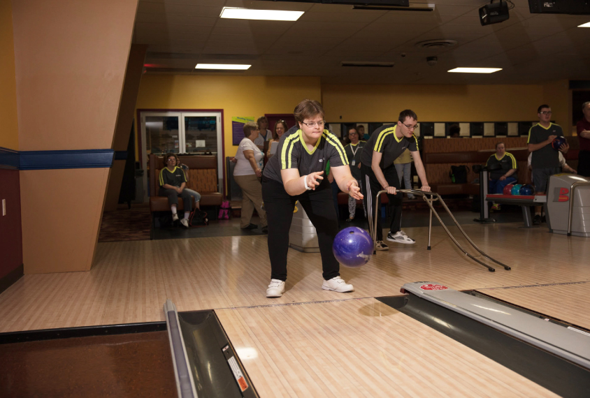 Photo: Becky Audette tosses a purple bowling ball down the bowling lane.