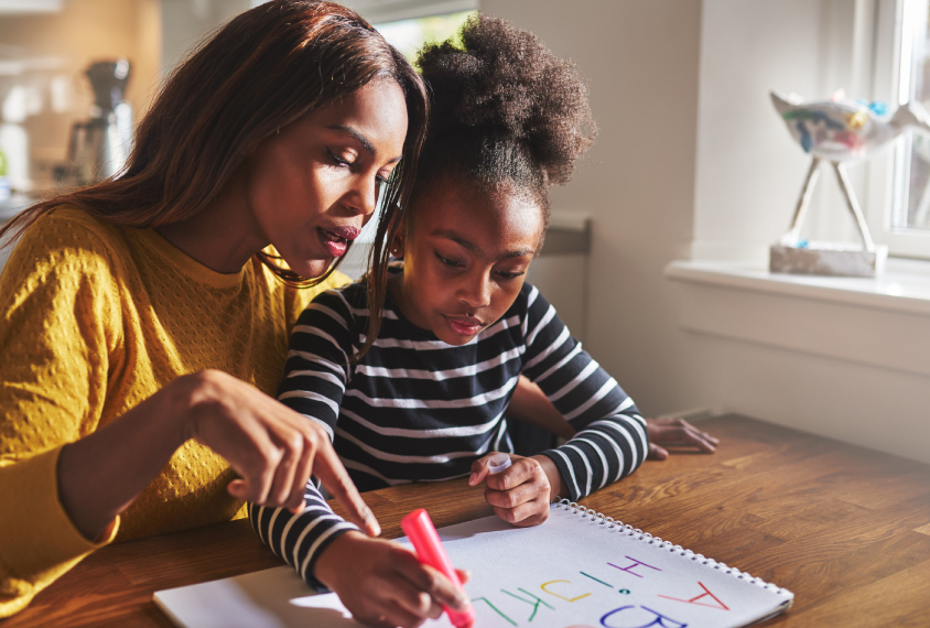 Mother and daughter practicing writing.