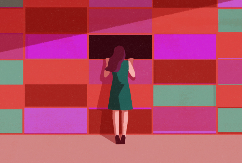 A woman peers through a wall made to look like a genetic sequencing background, through a missing area.