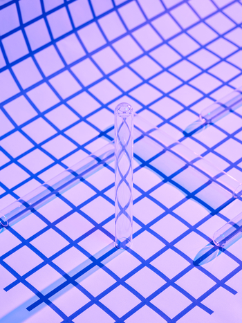 glass vial on blue grid pattern