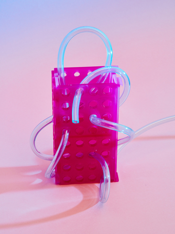 Piping on a lab tray, on pink background.