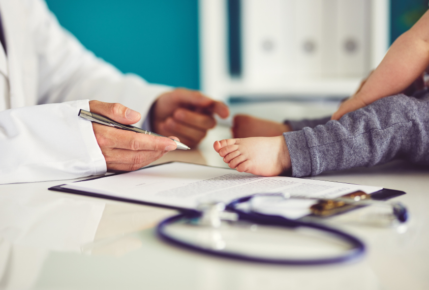 Doctor with toddler in medical office.