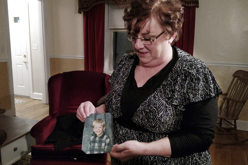 Mom Toni Hoy with ah photograph of her adopted son.