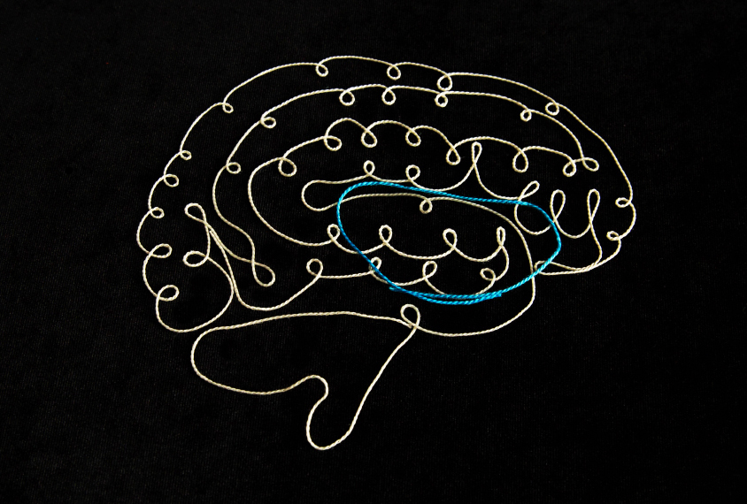 brain made of thread shows OCD loop in colored thread