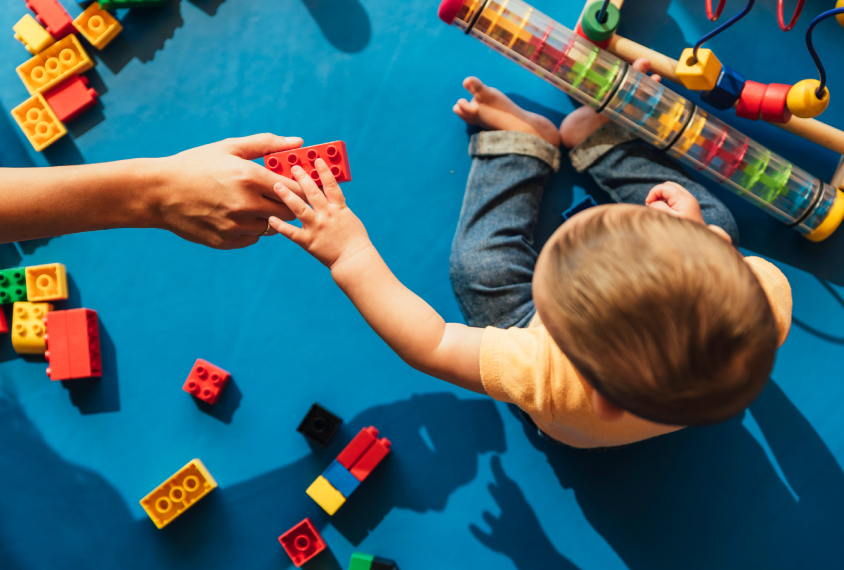 baby reaching for toy