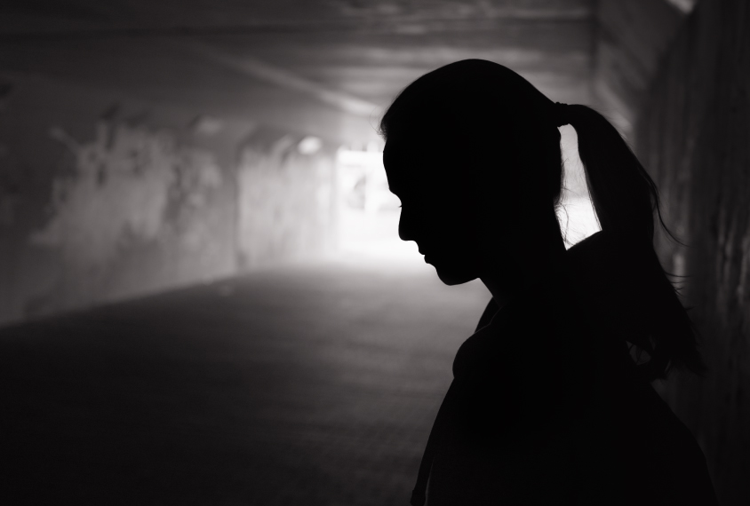 A depressed young woman in a tunnel