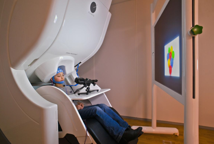 Child in magnetoencephalograph (MEG) scanner