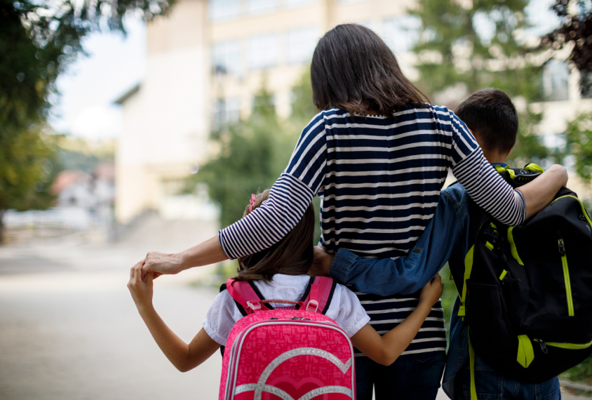 A mother taking her two children to school