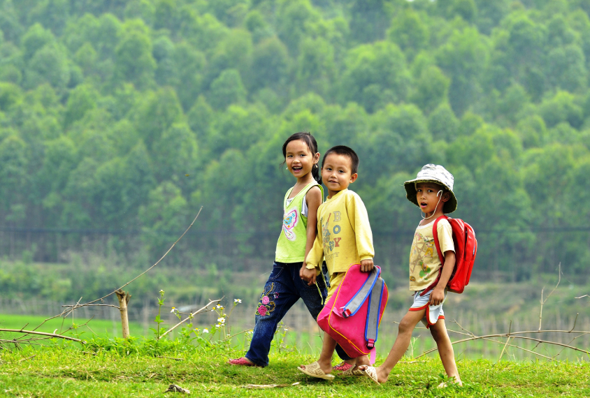 Group of children walking in the countryside in Vietnam.