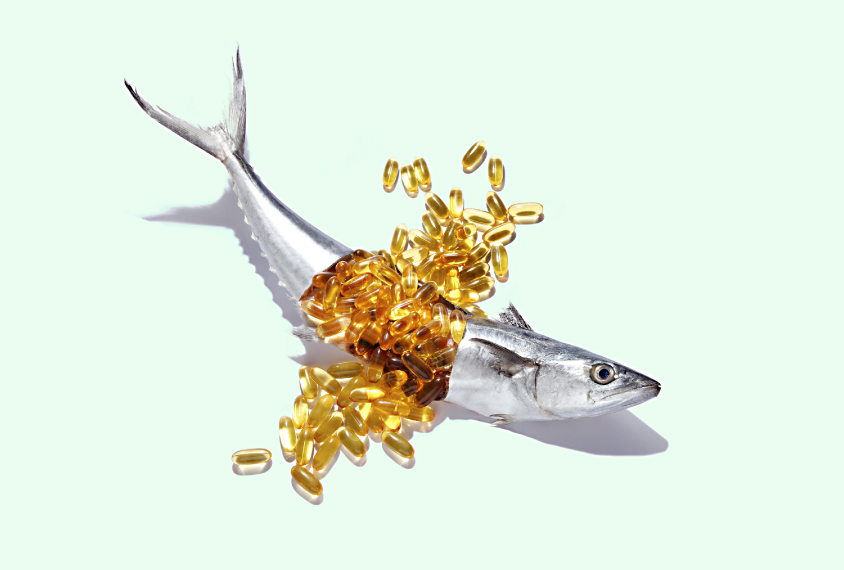 Fish with fish oil capsules spilling out of it.