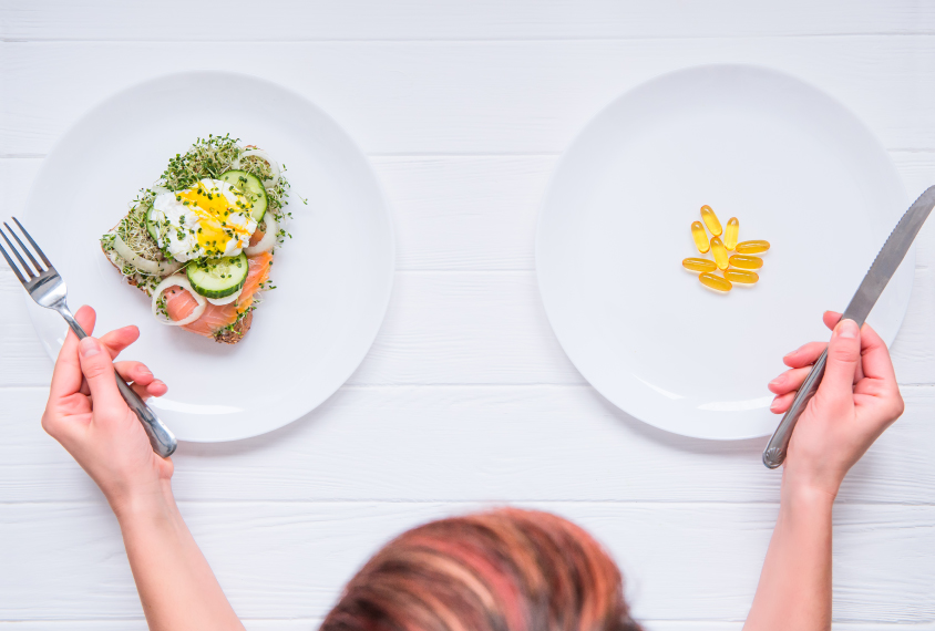 Choosing between two plates: on the left, salmon and on the right, supplements.