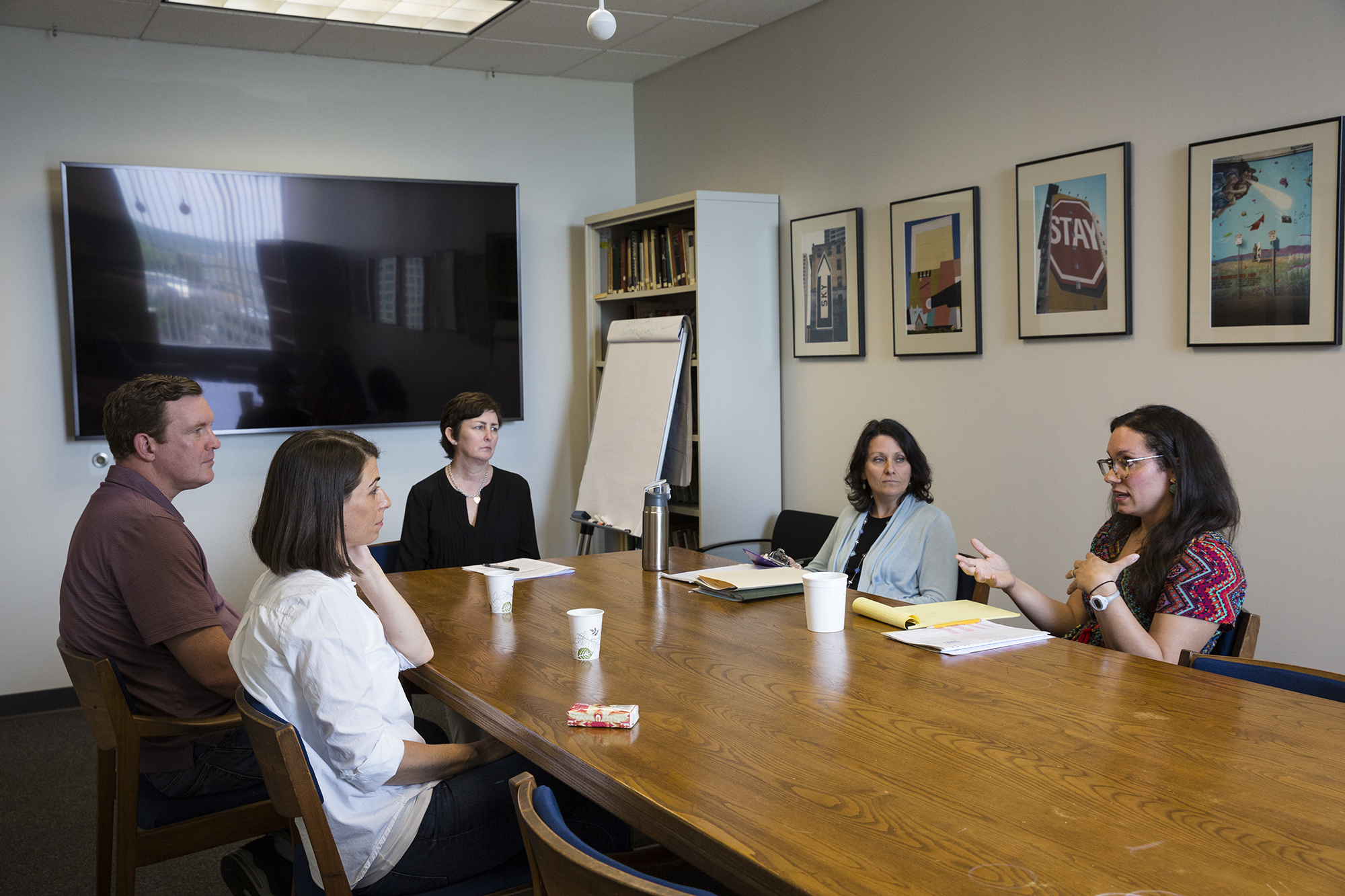 Photo: Owen's parents sit around a wooden table with a team of physicians.