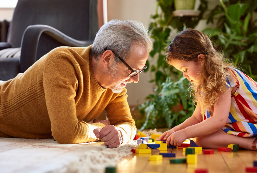 Mature dad and his daughter plays with blocks