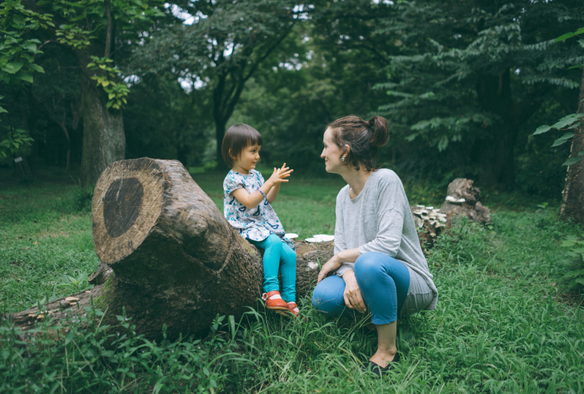 Mother and child having a conversation in nature.