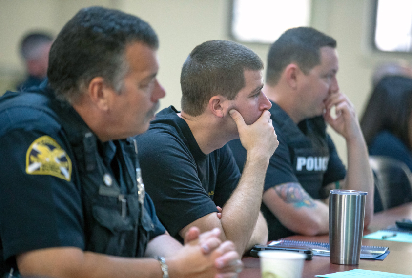 Police in training session classroom.