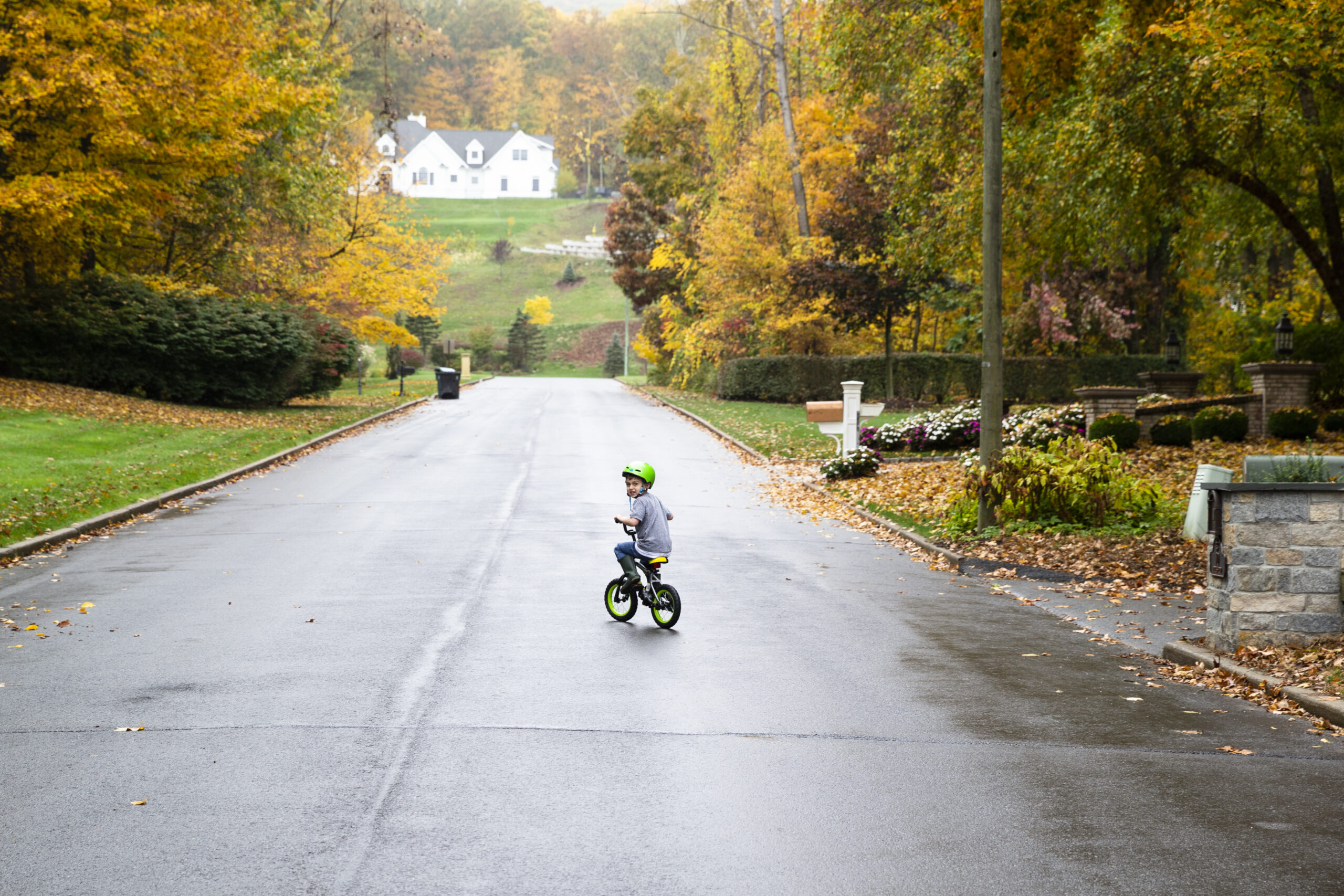 Owen Couture riding a bike in the street near his home.