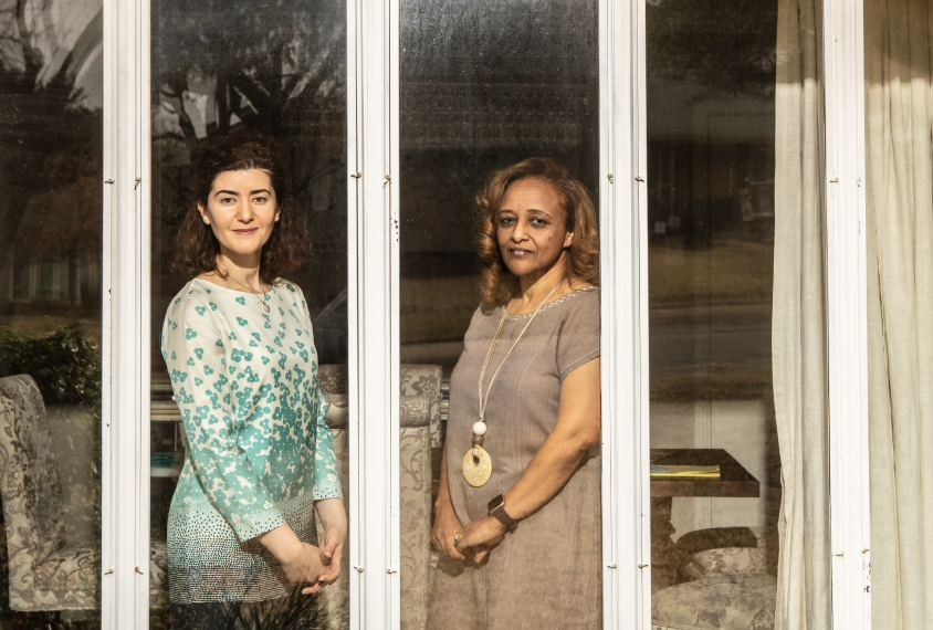 Maria Chahrour and Leah Seyoum-Tesfa framed by a window at Maria's home.