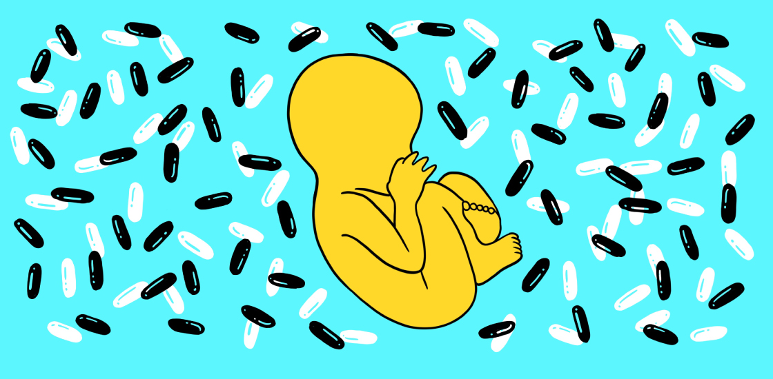 Baby in utero surrounded by pills, on bright blue background