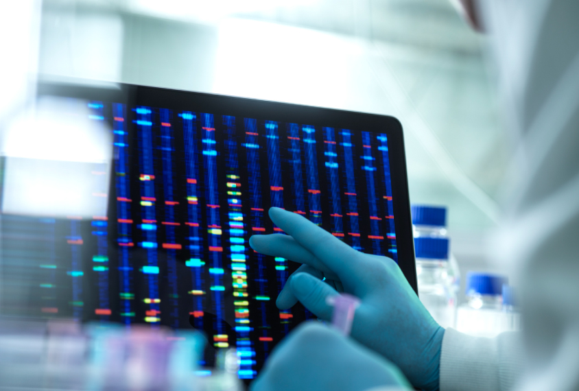 Genetic sequencing on computer screen in lab setting.