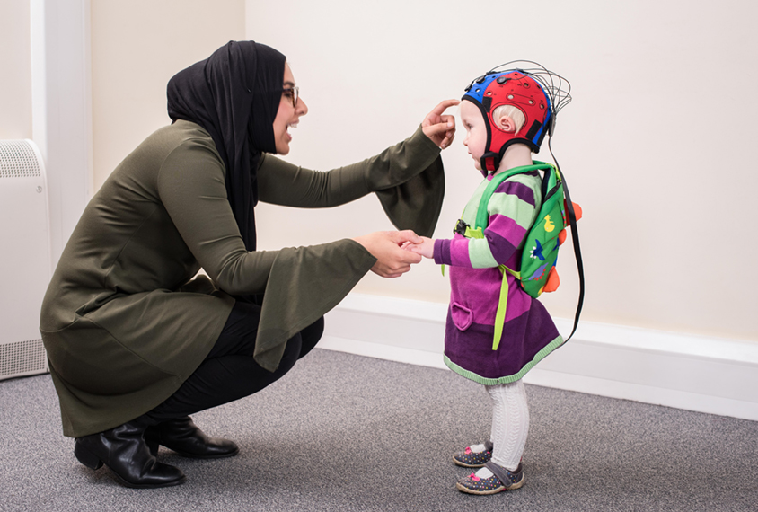 Woman talks to child in EEG cap