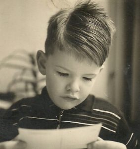 Photograph of Siem reading a postcard.