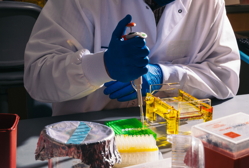 lab technician pipetting in dramatic light