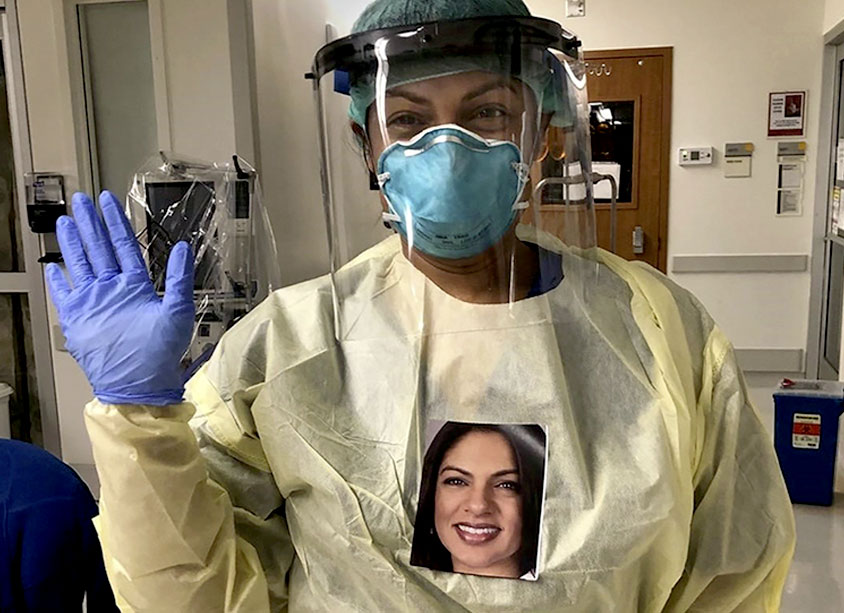 Healthcare provider wearing PPP and portrait photo on chest.
