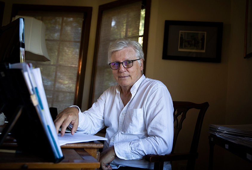 Portrait of Dr. Eric Fombonne working at his desk at home.