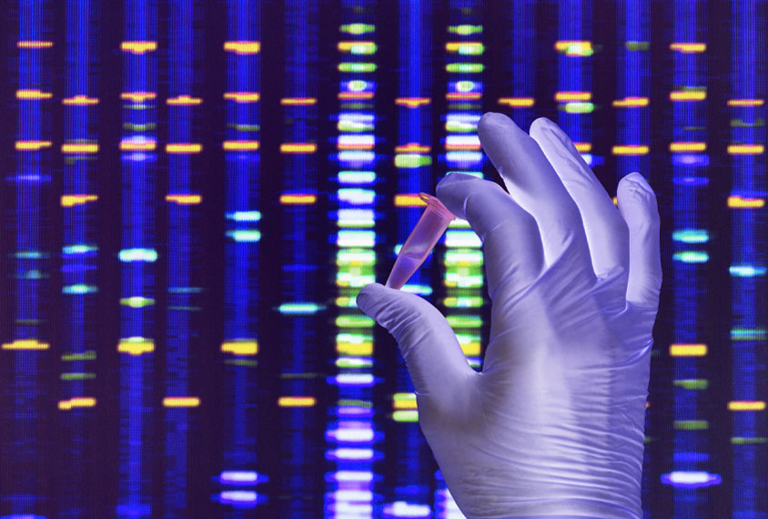 A gloved-hand holds up a vial against a background of colorful lights that represent a sequenced genome.