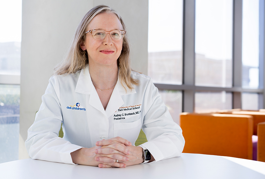 Portrait of a smiling Dr. Audrey Brumback in her lab coat.