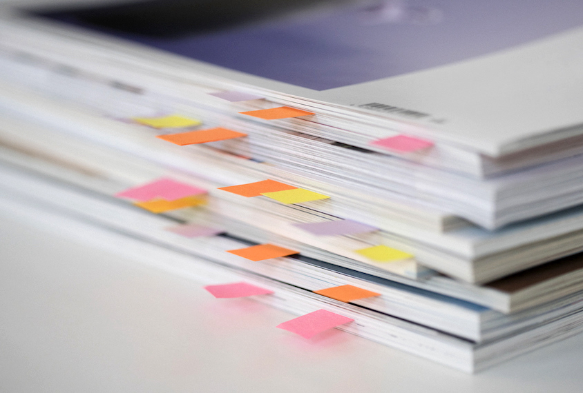 Stack of bookmarked journals.