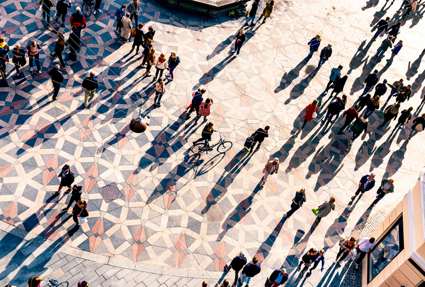 Overhead view of crowd of people walking in Copenhagen city square.