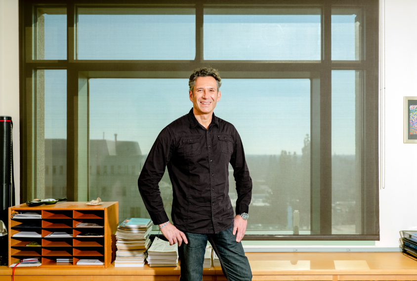 Dr. Kostas Zarbalis standing in front of a window in his office.