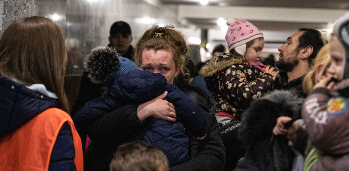 Ukrainian families seen waiting for a train to Poland. Lviv, the largest city in western Ukraine, has now become a transit hub for women and children fleeing to Europe, while men return and travel to eastern Ukraine to defend the country.