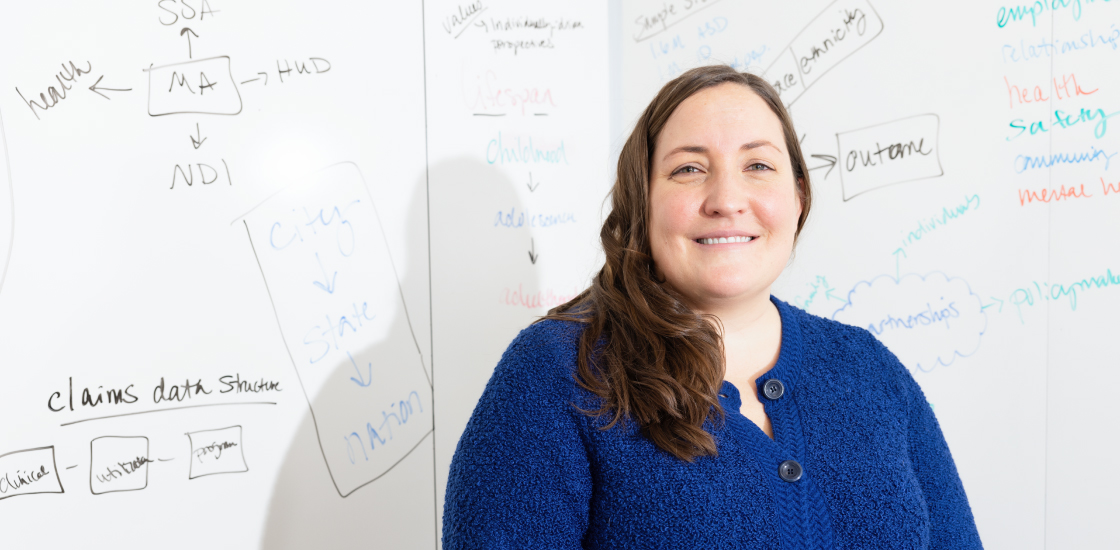 Lindsay Shea standing in front of a white board.