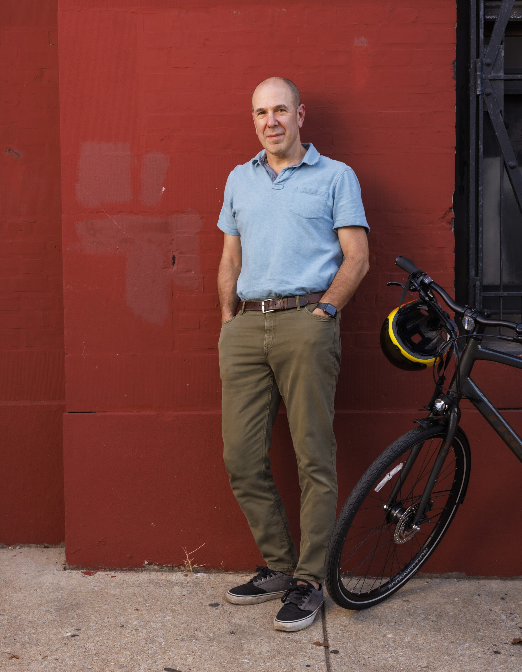 Autism researcher David Mandell stands against a red wall.