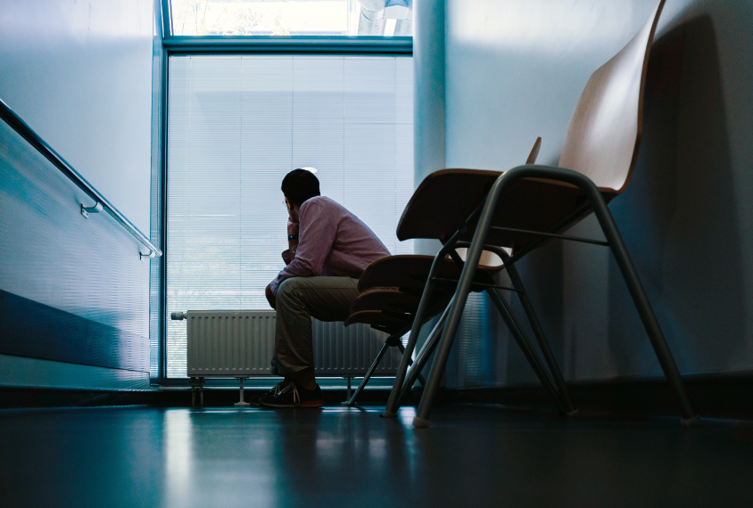 A patient sits in the waiting room of a doctor's office.