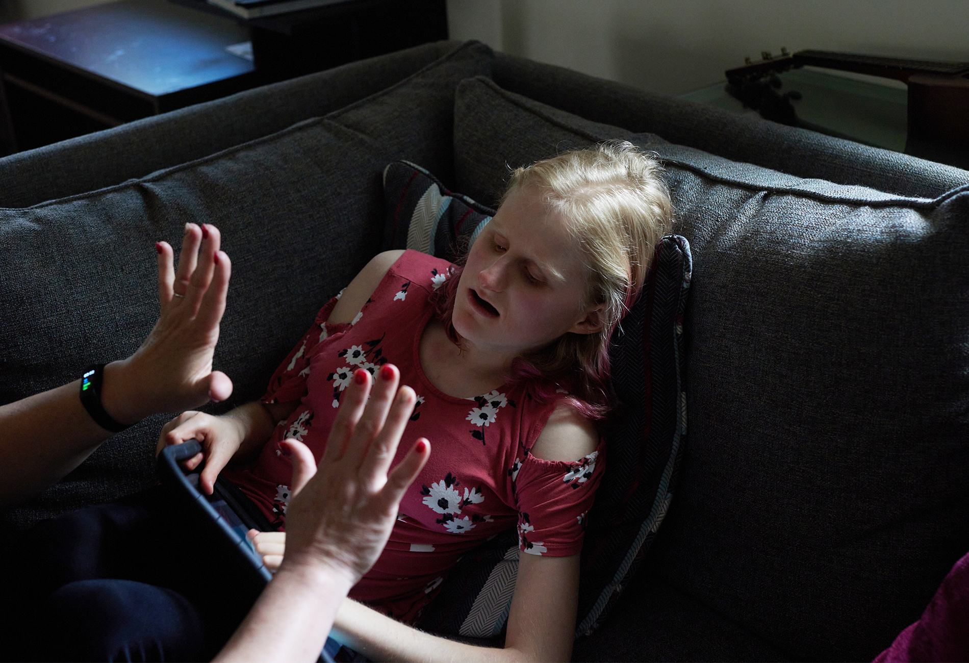 Sophie Burdine using an ipad with her mother at her home in New Jersey.